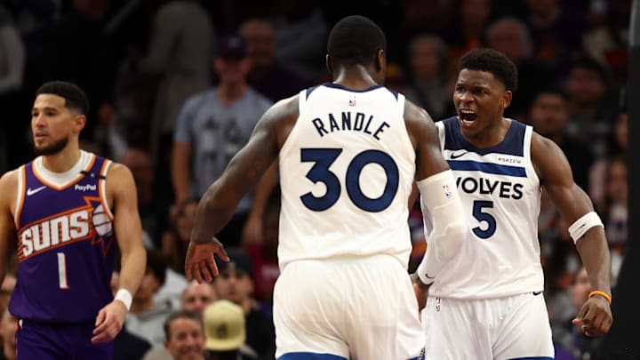 Jan 29, 2025; Phoenix, Arizona, USA; Minnesota Timberwolves guard Anthony Edwards (5) reacts with  forward Julius Randle (30) against the Phoenix Suns in the second half at Footprint Center. Mandatory Credit: Mark J. Rebilas-Imagn Images