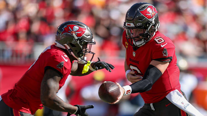Jan 5, 2025; Tampa, Florida, USA; Tampa Bay Buccaneers quarterback Baker Mayfield (6) hands off to running back Bucky Irving (7) against the New Orleans Saints in the second quarter  at Raymond James Stadium. Mandatory Credit: Nathan Ray Seebeck-Imagn Images