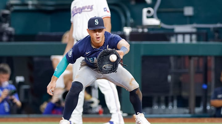 Seattle Mariners first baseman Dylan Moore (25) catches a throw over to first base during the seventh inning against the Texas Rangers at Globe Life Field on Sept 21.