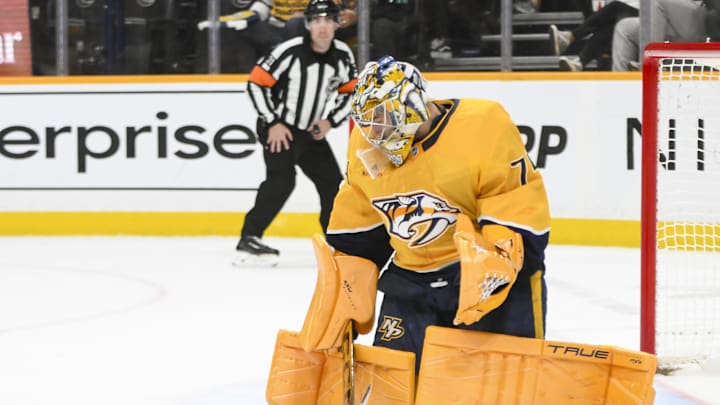 Apr 16, 2025; Nashville, Tennessee, USA;  Nashville Predators goaltender Juuse Saros (74) blocks the puck against the Dallas Stars during the second period at Bridgestone Arena. Mandatory Credit: Steve Roberts-Imagn Images