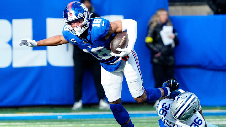 New York Giants wide receiver Darius Slayton (18) breaks a tackle attempt by Dallas Cowboys cornerback Corey Ballentine (36) before getting a Big Blue first down, Sunday, January 4, 2026, in East Rutherford.