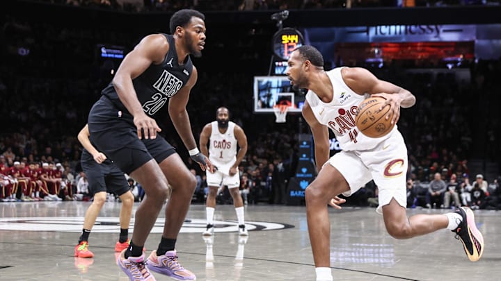 Mar 1, 2026; Brooklyn, New York, USA; Cleveland Cavaliers center Evan Mobley (4) looks to drive past Brooklyn Nets center Day'ron Sharpe (20) in the first quarter at Barclays Center. Mandatory Credit: Wendell Cruz-Imagn Images