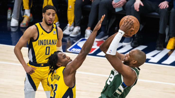 May 2, 2024; Indianapolis, Indiana, USA; Milwaukee Bucks forward Khris Middleton (22) shoots the ball while Indiana Pacers forward Aaron Nesmith (23)  defends during game six of the first round for the 2024 NBA playoffs at Gainbridge Fieldhouse. Mandatory Credit: Trevor Ruszkowski-USA TODAY Sports