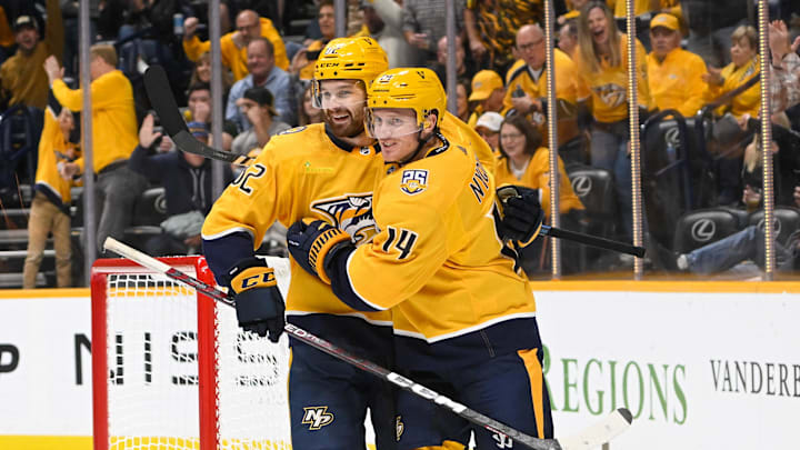 Oct 21, 2023; Nashville, Tennessee, USA;  Nashville Predators left wing Gustav Nyquist (14) celebrates the goal of center Tommy Novak (82) against the San Jose Sharks during the third period at Bridgestone Arena. Mandatory Credit: Steve Roberts-Imagn Images
