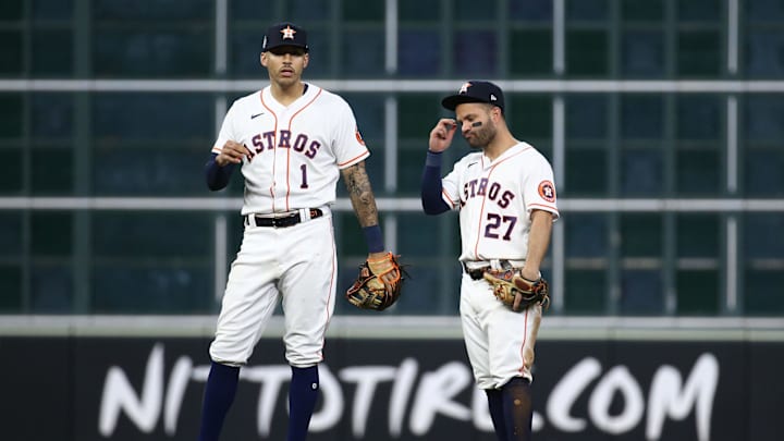 Nov 2, 2021; Houston, TX, USA; Houston Astros infielders Carlos Correa (1) and Jose Altuve (27) react during the eighth inning against the Atlanta Braves in game six of the 2021 World Series at Minute Maid Park. Mandatory Credit: Troy Taormina-Imagn Images