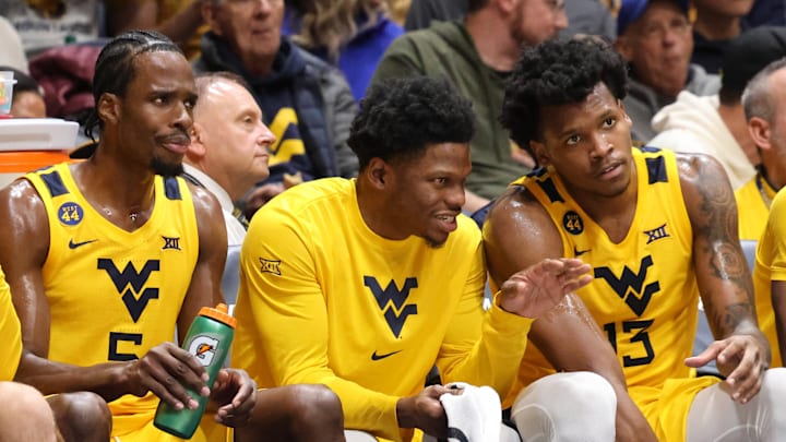 West Virginia University guard Toby Okani (5), guard Joseph Yesufu (middle), and forward Amani Hansberry. 