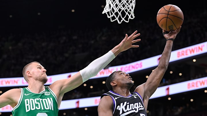 Apr 5, 2024; Boston, Massachusetts, USA; Sacramento Kings guard De'Aaron Fox (5) shoots a lay up  against Boston Celtics center Kristaps Porzingis (8) during the second half at TD Garden. Mandatory Credit: Eric Canha-USA TODAY Sports