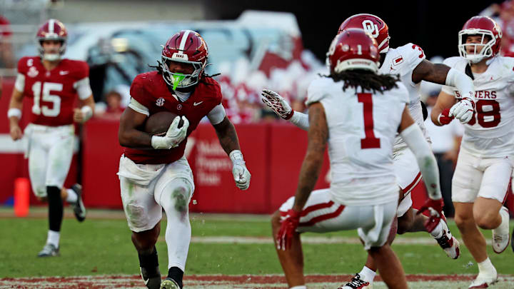 Nov 15, 2025; Tuscaloosa, Alabama, USA;  Alabama Crimson Tide running back Daniel Hill (4) runs the ball against Oklahoma Sooners defensive back Jaydan Hardy (1) during the first half at Saban Field at Bryant-Denny Stadium. Mandatory Credit: David Leong-Imagn Images