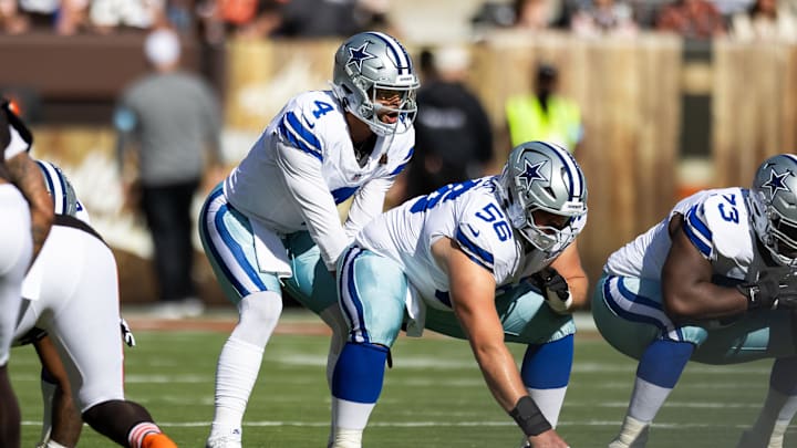 Dallas Cowboys quarterback Dak Prescott lines up behind center Cooper Beebe