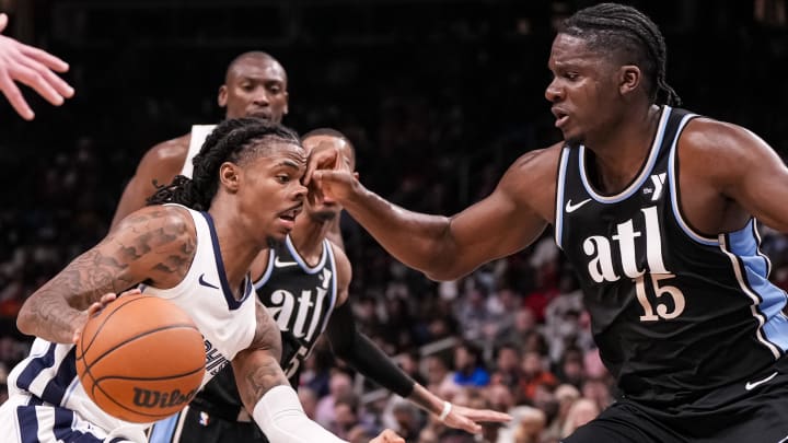 Dec 23, 2023; Atlanta, Georgia, USA; Memphis Grizzlies guard Ja Morant (12) gets hit in the face while being defended by Atlanta Hawks center Clint Capela (15) during the second half at State Farm Arena. Mandatory Credit: Dale Zanine-USA TODAY Sports Dec 23, 2023; Atlanta, Georgia, USA; Memphis Grizzlies guard Ja Morant (12) gets hit in the face while being defended by Atlanta Hawks center Clint Capela (15) during the second half at State Farm Arena. Mandatory Credit: Dale Zanine-USA TODAY Sports