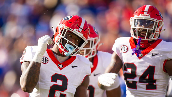 Georgia Bulldogs linebacker Smael Mondon Jr. (2) celebrates his tackle of Florida Gators running back Trevor Etienne (7) at Everbank Stadium in Jacksonville, FL on Saturday, October 28, 2023. [Doug Engle/Gainesville Sun]