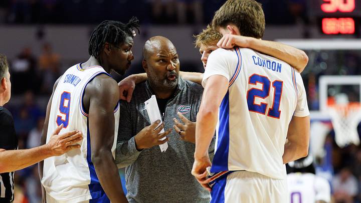 Nov 6, 2025; Gainesville, Florida, USA; Florida Gators associate head coach Carlin Hartman talks with Florida Gators center Rueben Chinyelu (9), Florida Gators forward Thomas Haugh (10) and Florida Gators forward Alex Condon (21) during a timeout against the North Florida Ospreys during the first half at Exactech Arena at the Stephen C. O'Connell Center. Mandatory Credit: Matt Pendleton-Imagn Images