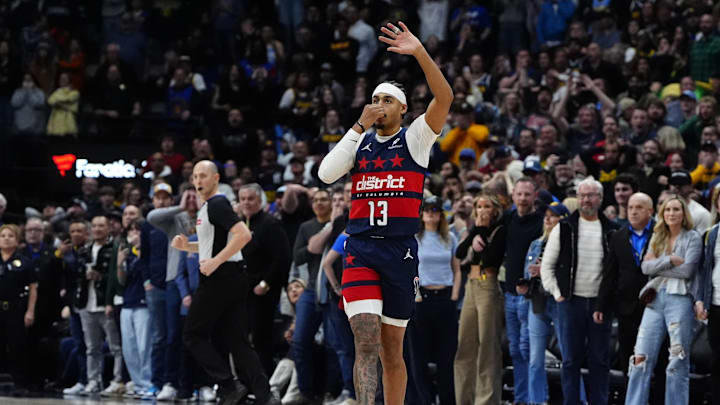Mar 15, 2025; Denver, Colorado, USA; Washington Wizards guard Jordan Poole (13) celebrates his game winning three-point basket with forward Kyshawn George (18) in the fourth quarter against the Denver Nuggets at Ball Arena. Mandatory Credit: Ron Chenoy-Imagn Images