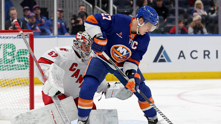 Jan 25, 2025; Elmont, New York, USA; New York Islanders left wing Anders Lee (27) plays the puck against Carolina Hurricanes goaltender Pyotr Kochetkov (52) during the third period at UBS Arena. Mandatory Credit: Brad Penner-Imagn Images Jan 25, 2025; Elmont, New York, USA; New York Islanders left wing Anders Lee (27) plays the puck against Carolina Hurricanes goaltender Pyotr Kochetkov (52) during the third period at UBS Arena. Mandatory Credit: Brad Penner-Imagn Images
