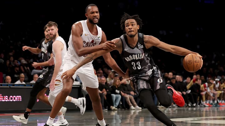 Dec 16, 2024; Brooklyn, New York, USA; Brooklyn Nets center Nic Claxton (33) drives to the basket against Cleveland Cavaliers forward Evan Mobley (4) during the fourth quarter at Barclays Center. Mandatory Credit: Brad Penner-Imagn Images