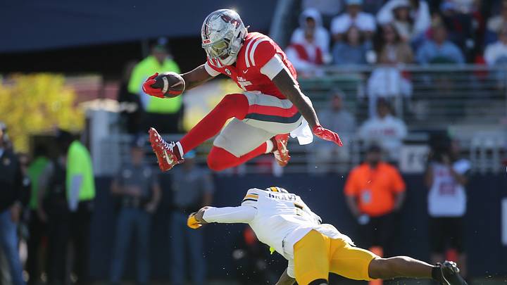 Oct 17, 2026; Oxford, Mississippi, USA; Mississippi Rebels running back Kewan Lacy (5) leaps over Missouri Tigers cornerback Chris Graves Jr. (1) during the first half at Vaught-Hemingway Stadium. Mandatory Credit: Petre Thomas-Imagn Images Oct 17, 2026; Oxford, Mississippi, USA; Mississippi Rebels running back Kewan Lacy (5) leaps over Missouri Tigers cornerback Chris Graves Jr. (1) during the first half at Vaught-Hemingway Stadium. Mandatory Credit: Petre Thomas-Imagn Images