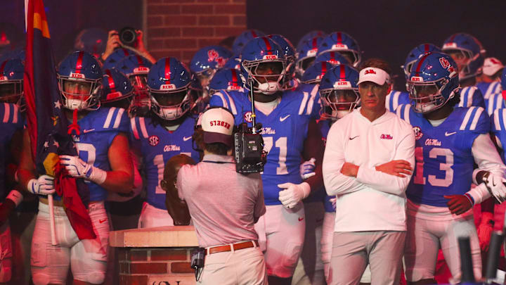 Nov 15, 2025; Oxford, Mississippi, USA; Mississippi Rebels head coach Lane Kiffin stands with his players before a game against the Florida Gators at Vaught-Hemingway Stadium. Mandatory Credit: Petre Thomas-Imagn Images