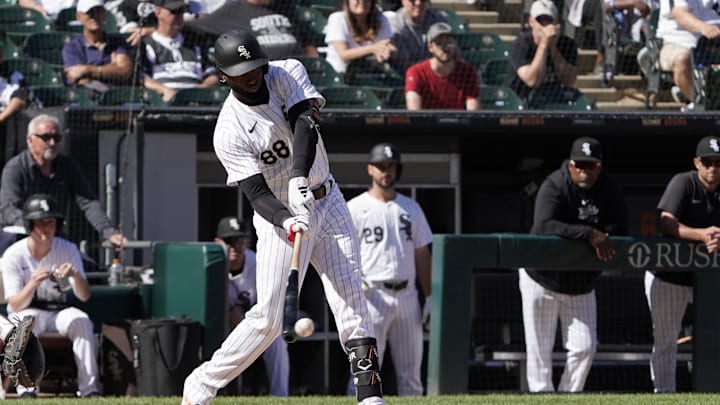 Jun 30, 2024; Chicago, Illinois, USA; Chicago White Sox outfielder Luis Robert Jr. (88) hits a single against the Colorado Rockies during the thirteenth inning at Guaranteed Rate Field. Mandatory Credit: David Banks-USA TODAY Sports