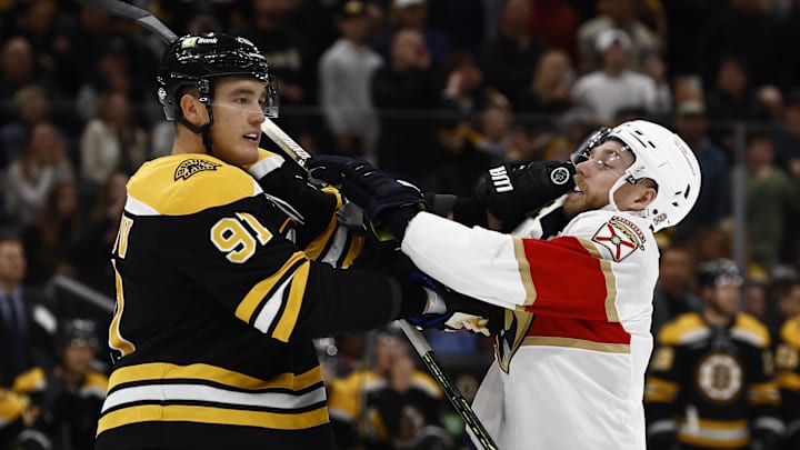 Oct 14, 2024; Boston, Massachusetts, USA; Boston Bruins defenseman Nikita Zadorov (91) mixes it up with Florida Panthers center Sam Bennett (9) during the first period at TD Garden. Mandatory Credit: Winslow Townson-Imagn Images