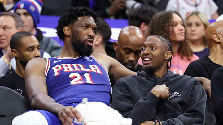 Mar 25, 2026; Philadelphia, Pennsylvania, USA; Philadelphia 76ers center Joel Embiid (21) and Tyrese Maxey (R) talk on the bench during the fourth quarter against the Chicago Bulls at Xfinity Mobile Arena. Mandatory Credit: Bill Streicher-Imagn Images