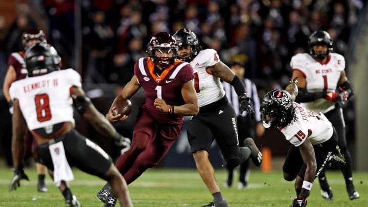 Nov 18, 2023; Blacksburg, Virginia, USA; Virginia Tech Hokies quarterback Kyron Drones (1) runs the ball against the North Carolina State Wolfpack at Lane Stadium. Mandatory Credit: Peter Casey-USA TODAY Sports