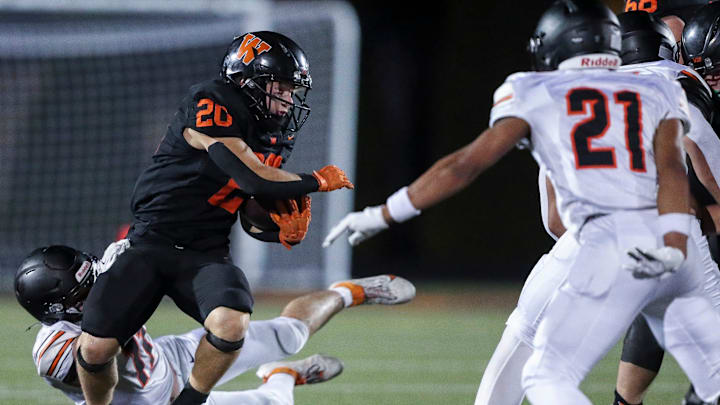 West De Pere High School's Ryan Lutz (20) breaks a tackle by Kaukauna High School's Wyatt Romenesko (11) on Friday, August 29, 2025, at West De Pere High School in De Pere, Wis. West De Pere won the game, 33-9.
Tork Mason/USA TODAY NETWORK-Wisconsin
