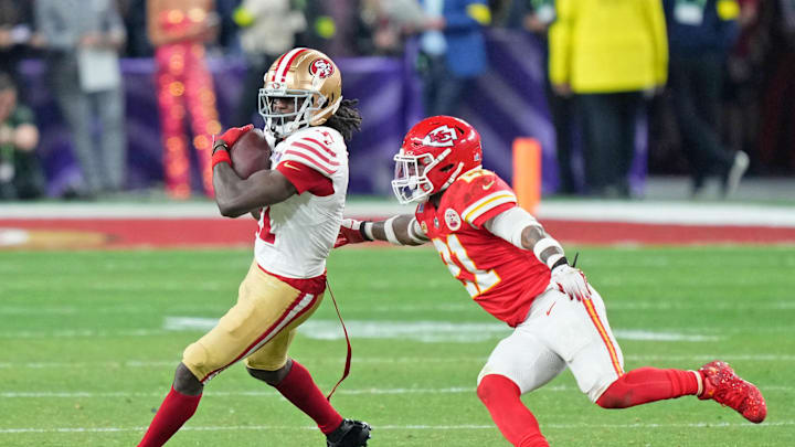 Feb 11, 2024; Paradise, Nevada, USA; San Francisco 49ers wide receiver Brandon Aiyuk (11) makes a catch against Kansas City Chiefs safety Mike Edwards (21) during overtime of Super Bowl LVIII at Allegiant Stadium. Mandatory Credit: Kyle Terada-Imagn Images
