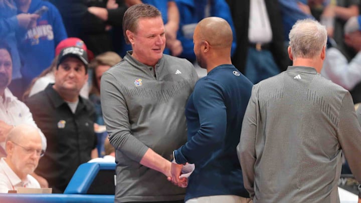 Kansas Jayhawks head coach Bill Self shakes hands with North Carolina-Wilmington Seahawks head coach Takayo Siddle before tip off of the game inside Allen Fieldhouse Tuesday, Nov. 19, 2024.