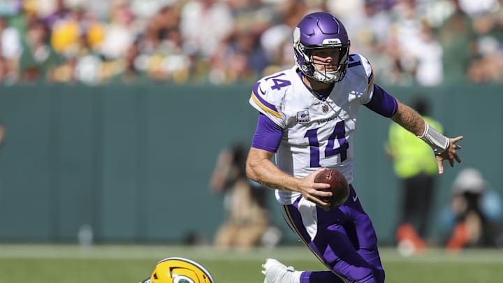 Sep 29, 2024; Green Bay, Wisconsin, USA; Minnesota Vikings quarterback Sam Darnold (14) escapes from Green Bay Packers defensive end Kingsley Enagbare (55) at Lambeau Field. Mandatory Credit: Tork Mason/USA TODAY Network via Imagn Images Sep 29, 2024; Green Bay, Wisconsin, USA; Minnesota Vikings quarterback Sam Darnold (14) escapes from Green Bay Packers defensive end Kingsley Enagbare (55) at Lambeau Field. Mandatory Credit: Tork Mason/USA TODAY Network via Imagn Images