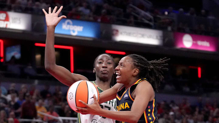 Seattle Storm center Ezi Magbegor (13) guards Indiana Fever guard Kelsey Mitchell (0) as she shoots the ball during the second half of a game Sunday, Aug. 18, 2024, at Gainbridge Fieldhouse in Indianapolis. The Fever defeated the Storm 92-75.