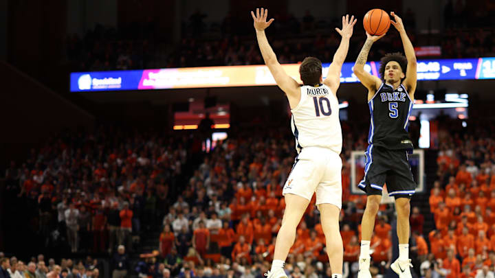 Feb 17, 2025; Charlottesville, Virginia, USA; Duke basketball guard Tyrese Proctor (5) shoots the ball as Virginia Cavaliers guard Taine Murray (10) defends in the first half at John Paul Jones Arena.