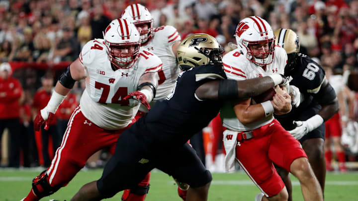 Purdue Boilermakers linebacker Nic Scourton (5) tackles Wisconsin Badgers quarterback Tanner Mordecai (8) during the NCAA football game, Friday, Sept. 22, 2023, at Ross-Ade Stadium in West Lafayette, Ind. Wisconsin Badgers won 38-17.