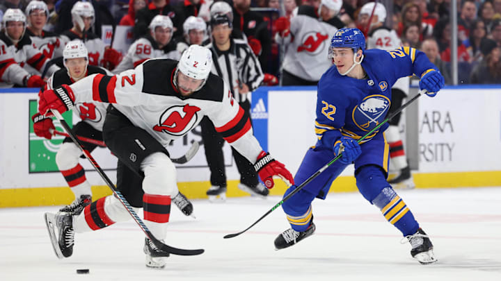 Mar 29, 2024; Buffalo, New York, USA;  New Jersey Devils defenseman Brendan Smith (2) tries to block a pass by Buffalo Sabres right wing Jack Quinn (22) during the second period at KeyBank Center. Mandatory Credit: Timothy T. Ludwig-Imagn Images