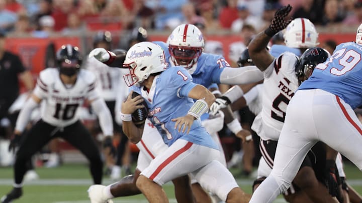 Oct 4, 2025; Houston, Texas, USA; Houston Cougars quarterback Conner Weigman (1) rushes against the Texas Tech Raiders in the first half at TDECU Stadium. Mandatory Credit: Thomas Shea-Imagn Images