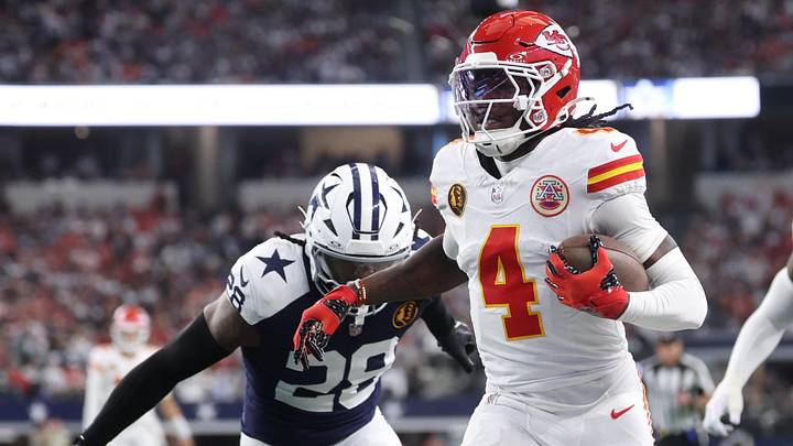 Nov 27, 2025; Arlington, Texas, USA; Kansas City Chiefs wide receiver Rashee Rice (4) runs with the ball past Dallas Cowboys safety Malik Hooker (28) during the first quarter at AT&T Stadium. Mandatory Credit: Kevin Jairaj-Imagn Images