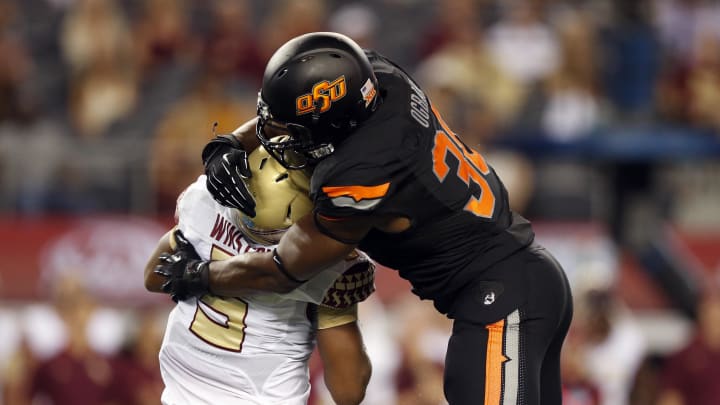 Aug 30, 2014; Arlington, TX, USA; Oklahoma State Cowboys defensive end Emmanuel Ogbah (38) tackles Florida State Seminoles quarterback Jameis Winston (5) during the second quarter at AT&T Stadium. Mandatory Credit: Matthew Emmons-USA TODAY Sports