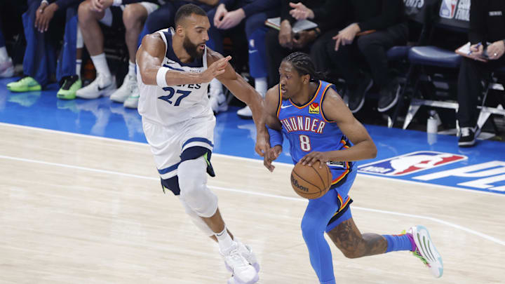 May 22, 2025; Oklahoma City, Oklahoma, USA; Oklahoma City Thunder forward Jalen Williams (8) dribbles against Minnesota Timberwolves center Rudy Gobert (27) in the second quarter during game two of the western conference finals for the 2025 NBA Playoffs at Paycom Center. Mandatory Credit: Alonzo Adams-Imagn Images