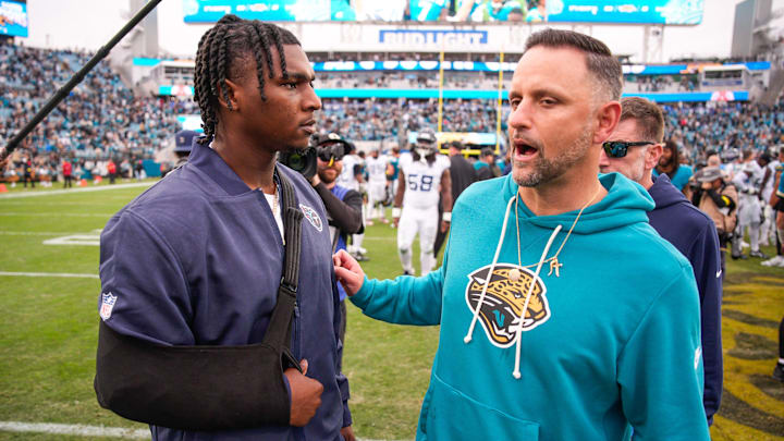 Tennessee Titans quarterback Cam Ward (1) talks with Jacksonville Jaguars defensive coordinator Anthony Campanile after the game at EverBank Stadium, Sunday, Jan. 4, 2026, in Jacksonville, Fla. The Jaguars defeated the Titans 41-7 [Doug Engle/Florida Times-Union]