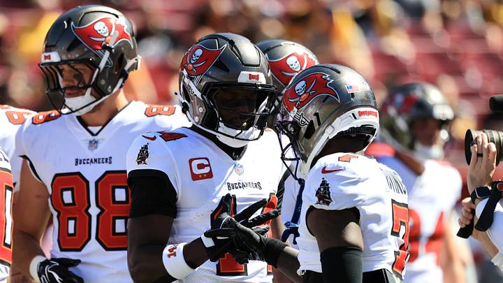 Oct 18, 2026; Tampa, Florida, USA;  Tampa Bay Buccaneers wide receiver Chris Godwin Jr. (14) speaks with Tampa Bay Buccaneers running back Bucky Irving (7) before the game against the Pittsburgh Steelers at Raymond James Stadium.  Mandatory Credit: Kim Klement Neitzel-Imagn Images