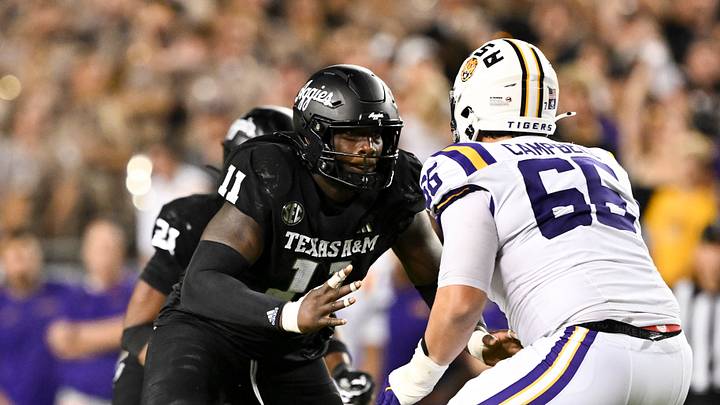 Oct 26, 2024; College Station, Texas, USA; Texas A&M Aggies defensive lineman Nic Scourton (11) defends in coverage against LSU Tigers offensive tackle Will Campbell (66) during the fourth quarter. The Aggies defeated the Tigers 38-23; at Kyle Field. Mandatory Credit: Maria Lysaker-Imagn Images.
