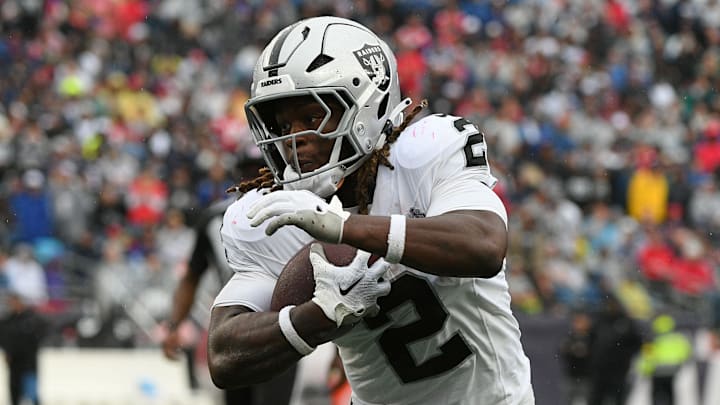 Sep 7, 2025; Foxborough, Massachusetts, USA; Las Vegas Raiders running back Ashton Jeanty (2) rushes the ball against the New England Patriots during he second half at Gillette Stadium. Mandatory Credit: Bob DeChiara-Imagn Images