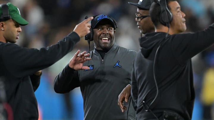 Nov 22, 2025; Pasadena, California, USA;  UCLA Bruins interim head coach Tim Skipper talks with coaches during the first half against the Washington Huskies at the Rose Bowl. Mandatory Credit: Jayne Kamin-Oncea-Imagn Images