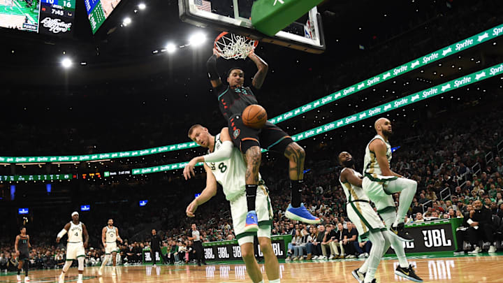 Washington Wizards forward Kyle Kuzma (33) dunks the ball past Boston Celtics center Kristaps Porzingis (8) during the first half at TD Garden. 