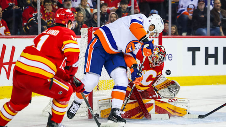 Jan 17, 2026; Calgary, Alberta, CAN; Calgary Flames goaltender Dustin Wolf (32) makes a save against New York Islanders left wing Anders Lee (27) during the first period at Scotiabank Saddledome. Mandatory Credit: Sergei Belski-Imagn Images
