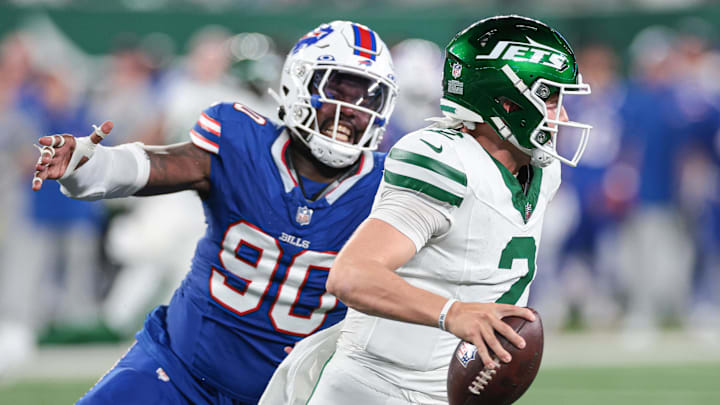 Sep 11, 2023; East Rutherford, New Jersey, USA; New York Jets quarterback Zach Wilson (2) avoids being sacked by Buffalo Bills defensive end Shaq Lawson (90)