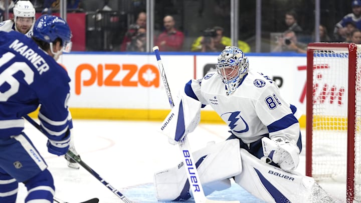 Oct 21, 2024; Toronto, Ontario, CAN; Tampa Bay Lightning goaltender Andrei Vasilevskiy (88) makes a save against Toronto Maple Leafs forward Mitch Marner (16) during the first period at Scotiabank Arena. Mandatory Credit: John E. Sokolowski-Imagn Images