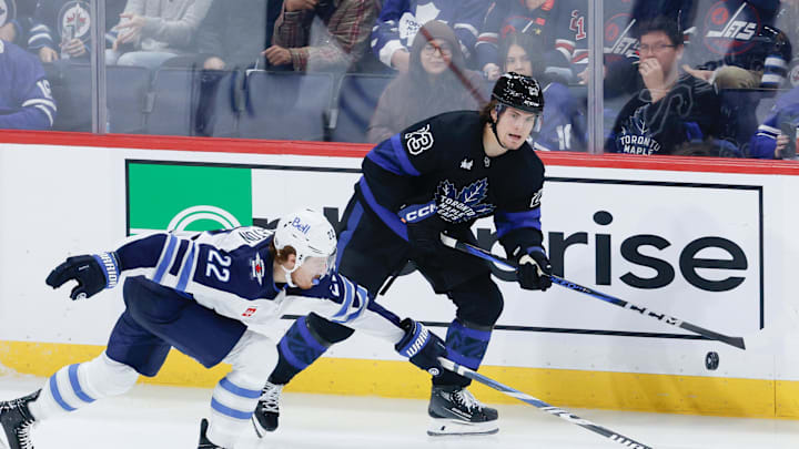 Oct 28, 2024; Winnipeg, Manitoba, CAN; Toronto Maple Leafs forward Matthew Knies (23) skates away from Winnipeg Jets forward Mason Appleton (22) during the third period at Canada Life Centre. Mandatory Credit: Terrence Lee-Imagn Images