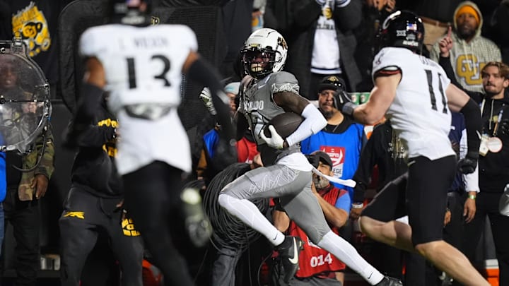 Oct 26, 2024; Boulder, Colorado, USA; Colorado Buffaloes wide receiver Travis Hunter (12) carries the ball in the second quarter against the Cincinnati Bearcats at Folsom Field. Mandatory Credit: Ron Chenoy-Imagn Images
