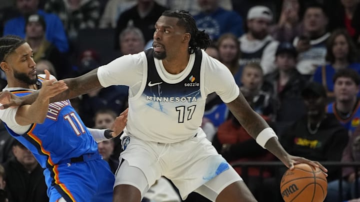Feb 13, 2025; Minneapolis, Minnesota, USA; Minnesota Timberwolves center Naz Reid (11) works against Oklahoma City Thunder guard Isaiah Joe (11) in the second quarter at Target Center. Mandatory Credit: Bruce Kluckhohn-Imagn Images