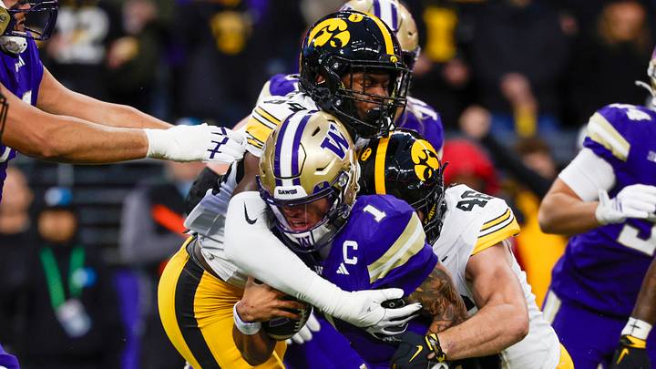 Oct 9, 2026; Seattle, Washington, USA; Iowa Hawkeyes defensive end Joseph Anderson (84) and linebacker Preston Ries (46) sack Washington Huskies quarterback Demond Williams Jr. (1) during the first quarter at Husky Stadium. Mandatory Credit: Joe Nicholson-Imagn Images